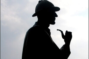 A man in a hat and smoking pipe.