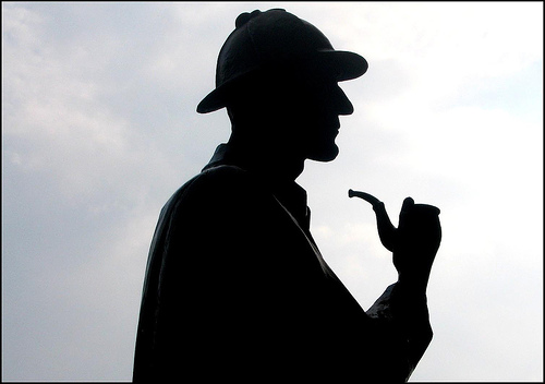 A man in a hat and smoking pipe.