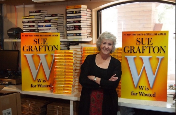 A woman standing in front of some books