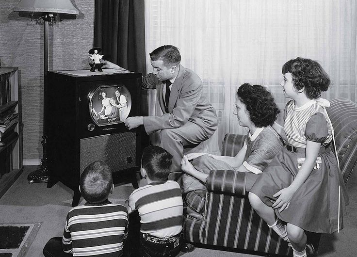 A family watching television in the living room.